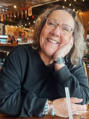 Kathy Jocoy smiling at a table
